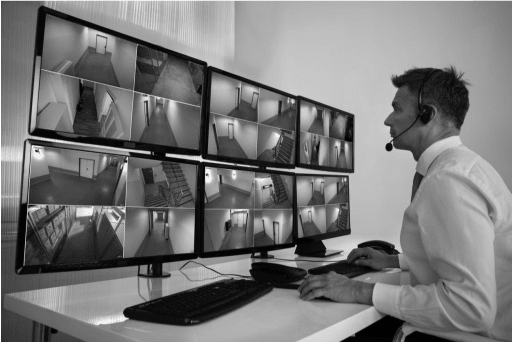 Security officer looking at security screens monitoring for any activity